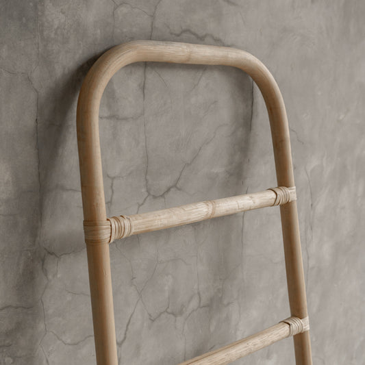 Bamboo ladder against a textured gray wall