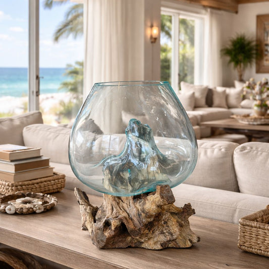 Decorative glass vase on a wooden table with a beach view in the background