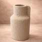 Textured beige vase on a matching background