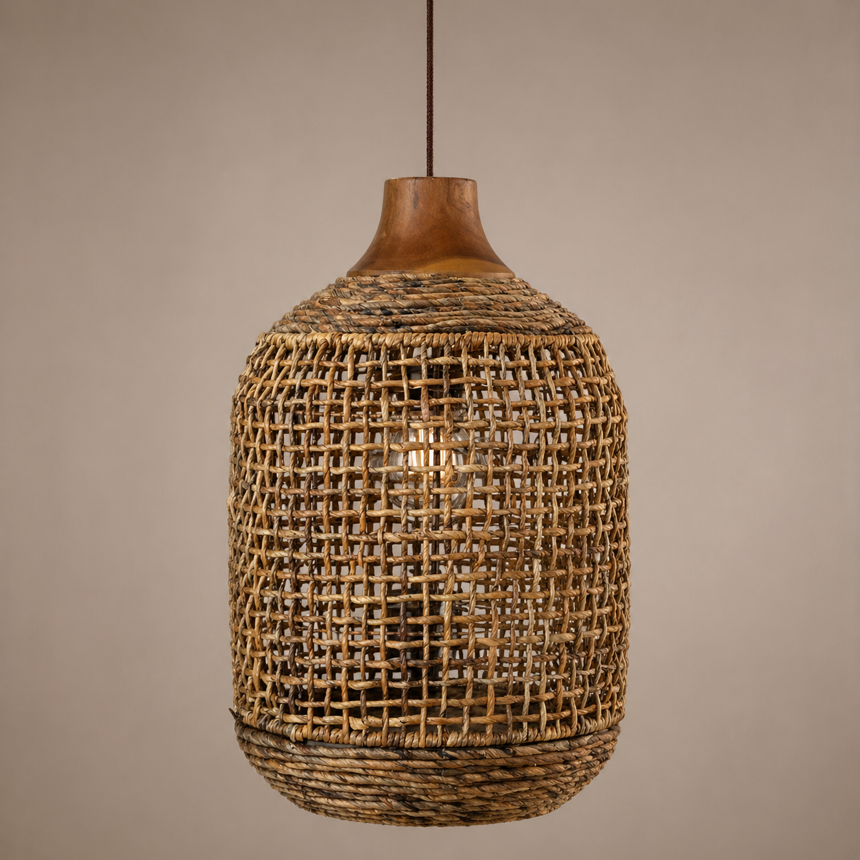 Woven rattan pendant light against a beige background