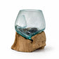 Clear glass bowl on a wooden base against a white background