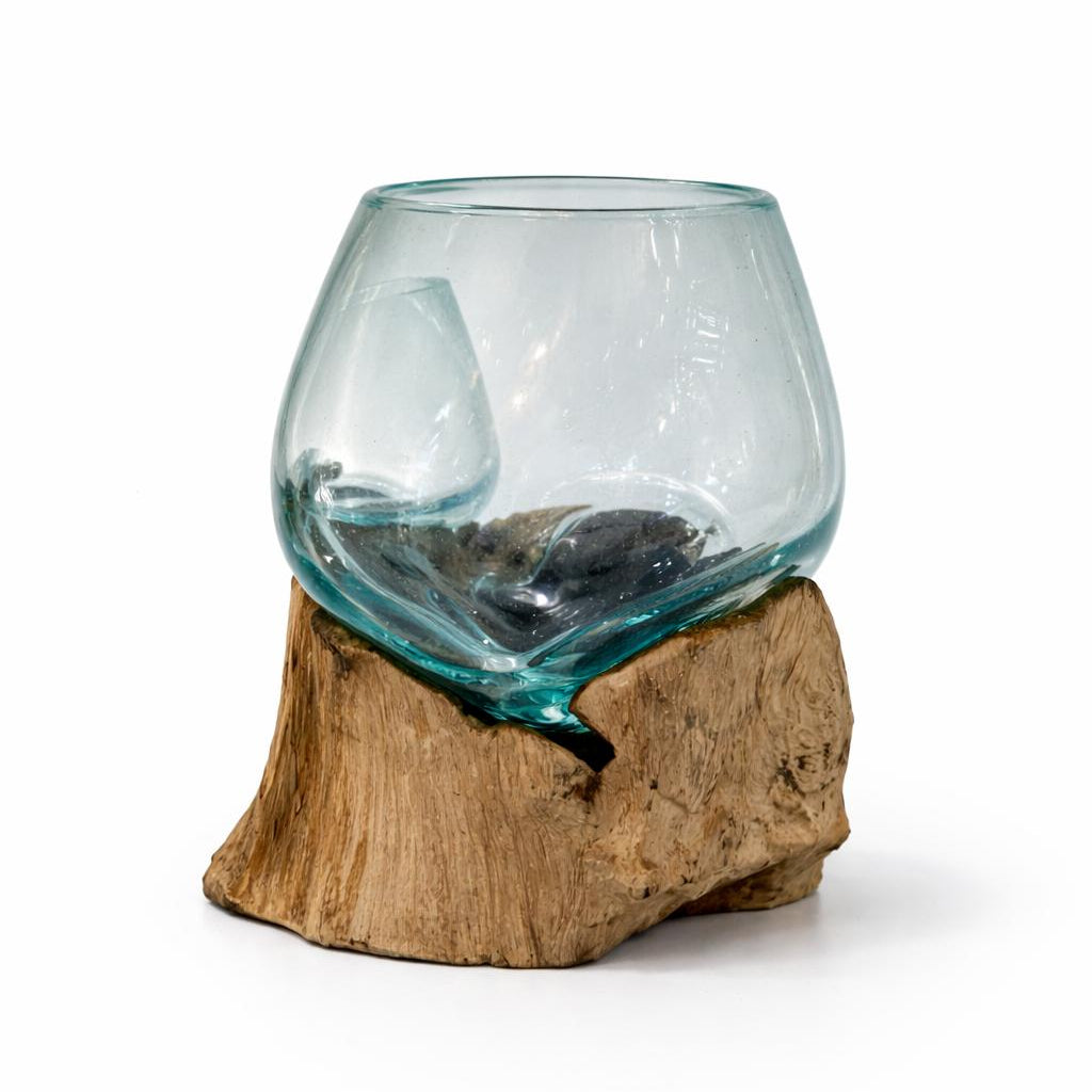 Clear glass bowl on a wooden base against a white background