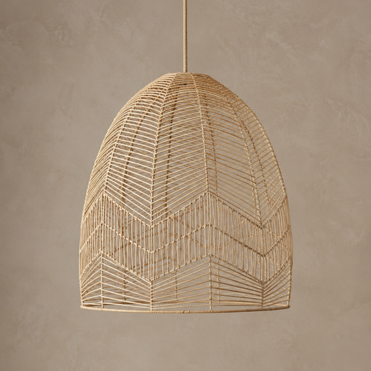 A woven pendant light with a natural rattan or wicker shade, suspended by a matching cord against a textured beige wall.