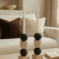 Decorative candle holder with candles on a coffee table in a living room setting. minimal