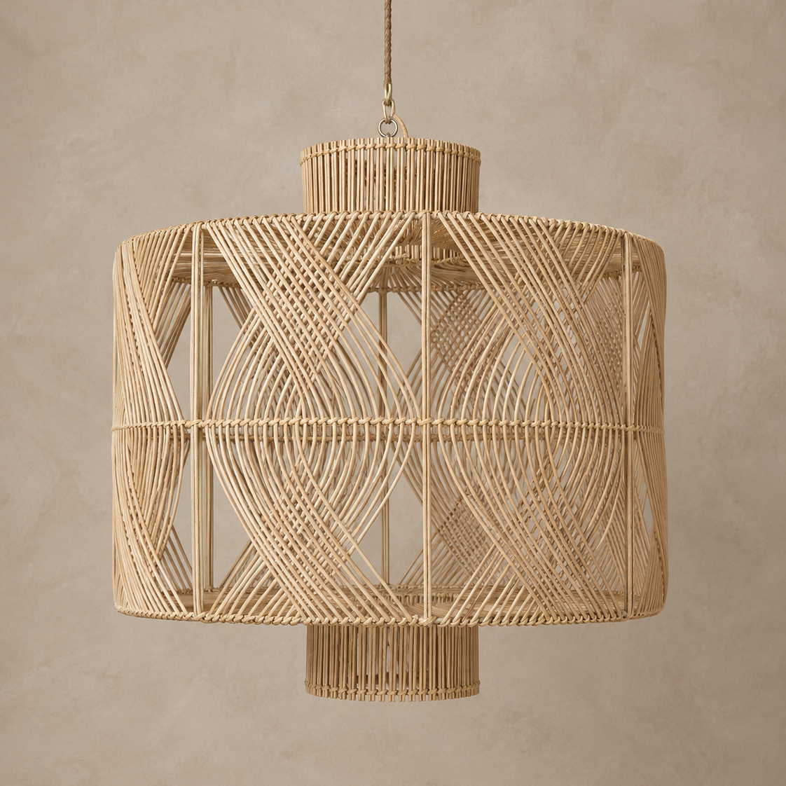 A natural woven rattan pendant chandelier with a geometric openwork design, suspended against a textured beige plaster wall.
