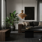 Modern living room with dark furniture, plants, and a pendant light.