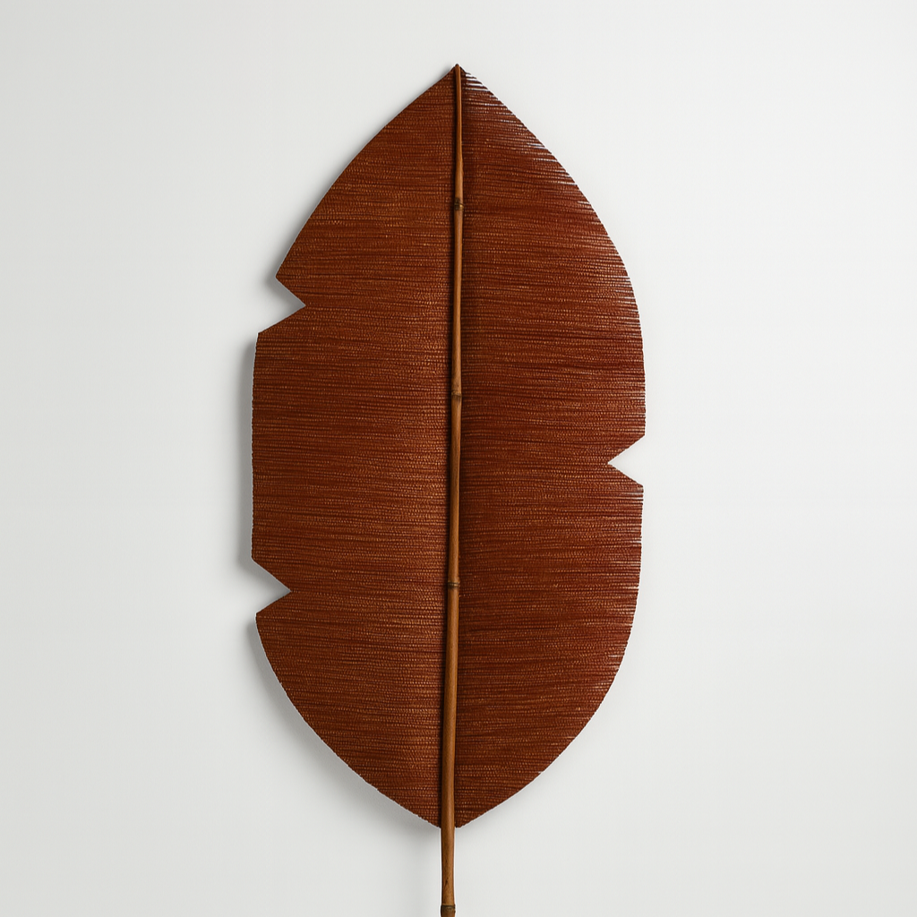 Brown leaf-shaped decorative item on a white background