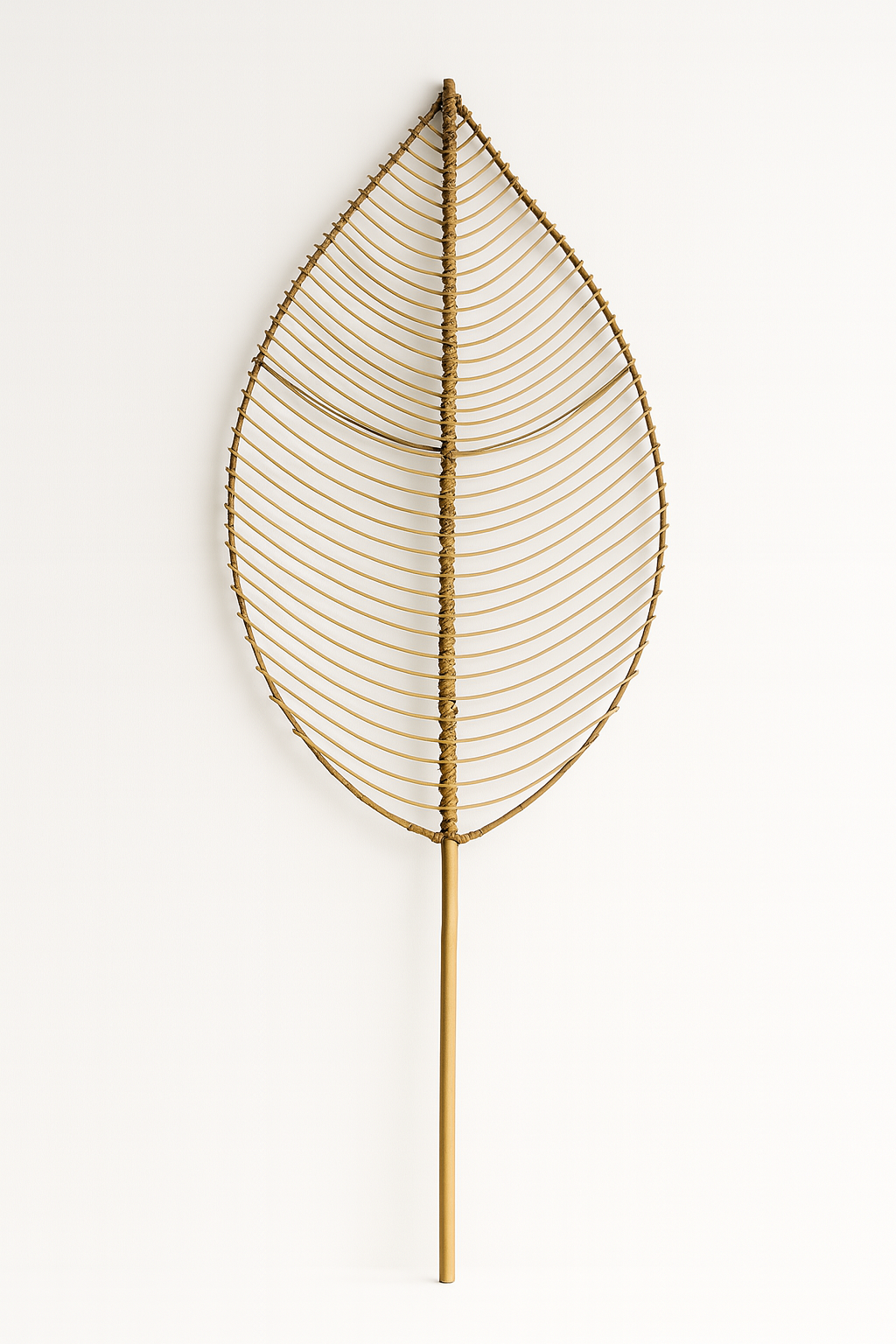 Decorative leaf-shaped wall art made of gold wire on a white background