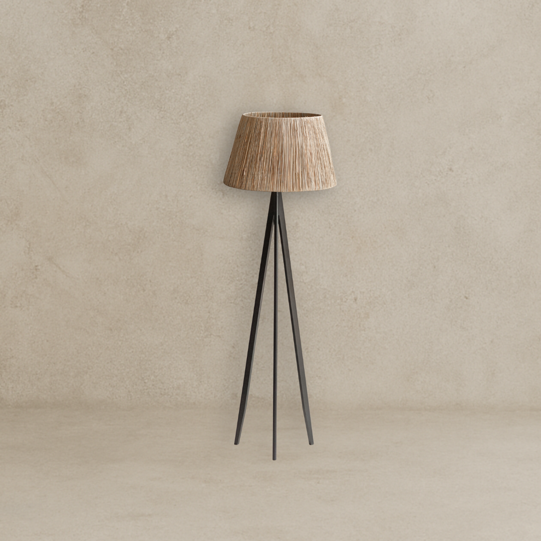 Floor lamp with a textured brown shade and black metal legs on a beige background
