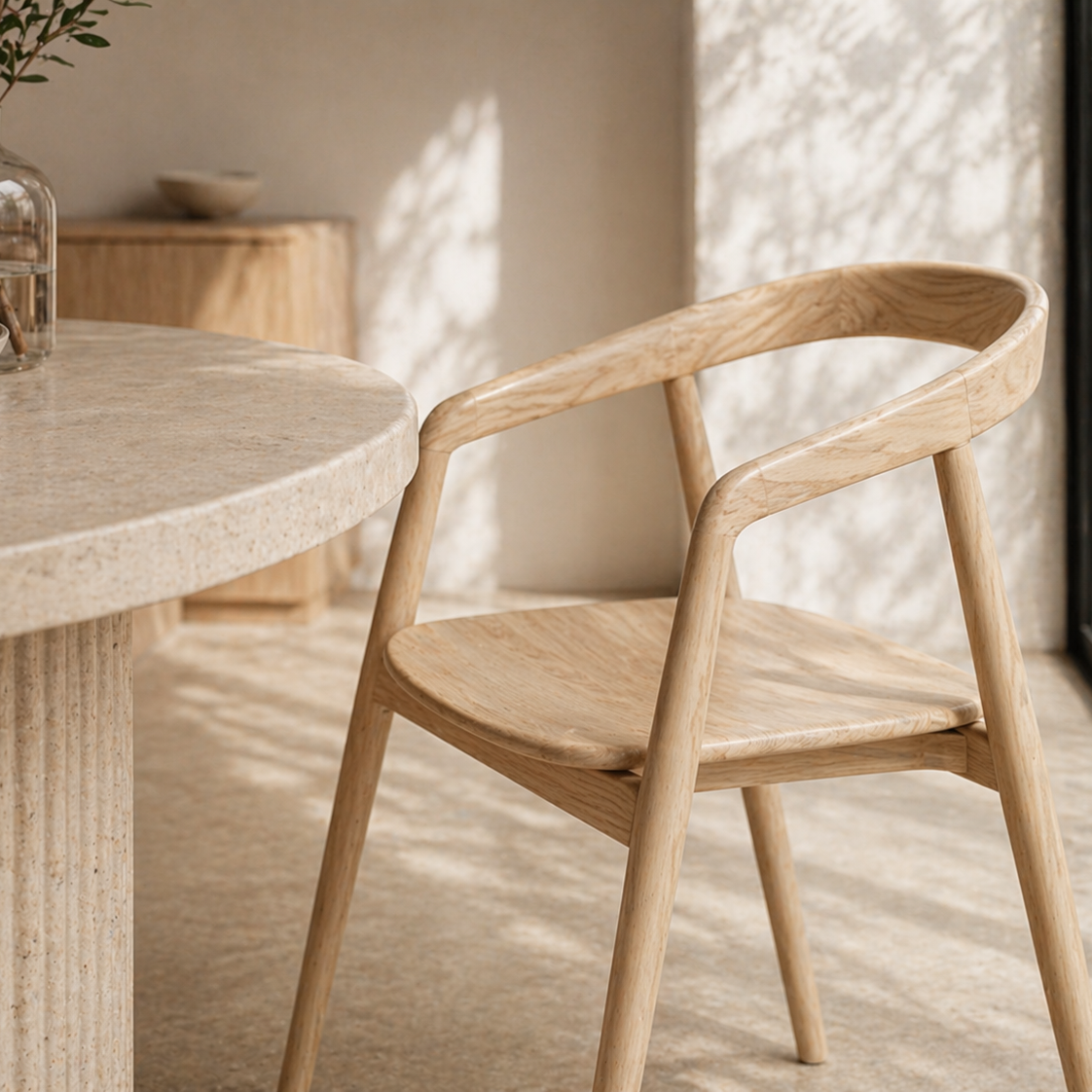 Wooden chair and dining table in a softly lit room with natural light.